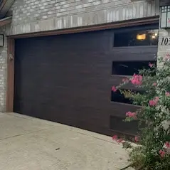 A garage door that is open and has three windows.