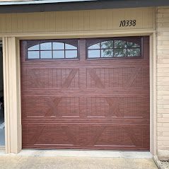A brown garage door with windows on the side of it.