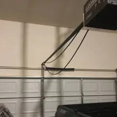 A garage door with wires hanging from it.